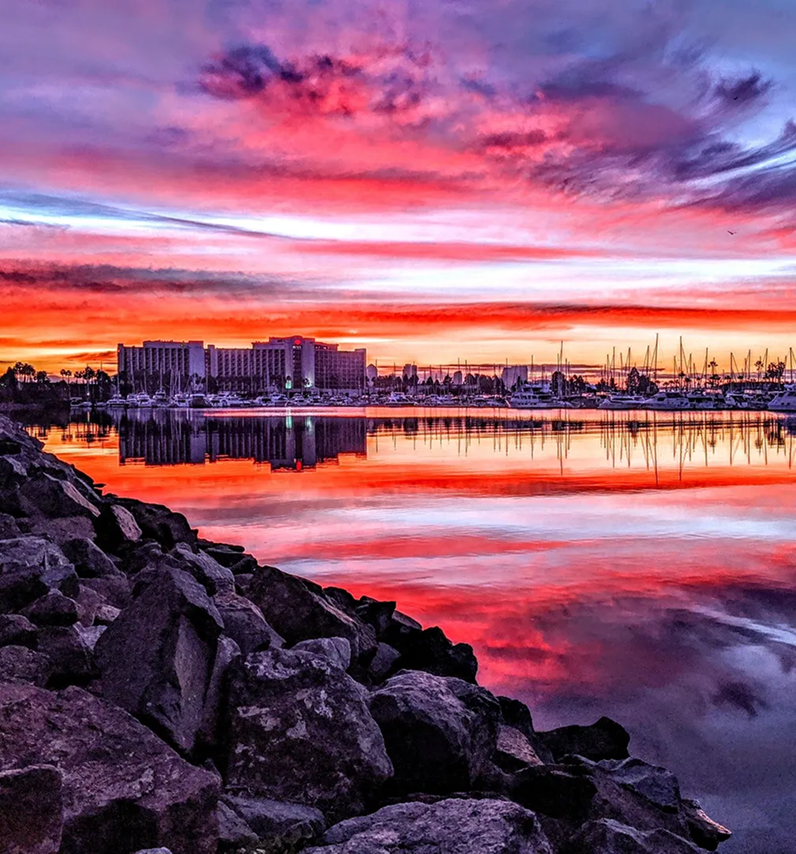Colorful sky reflecting on serene bay